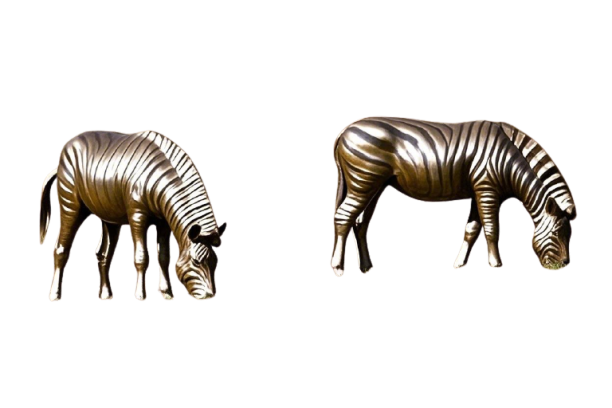 Two bronze-colored zebra sculptures, depicted grazing, positioned side-by-side against a black background.
